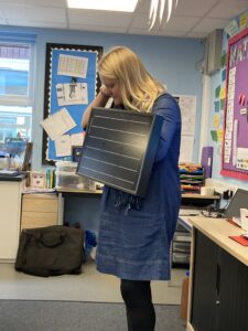 Juliette Jackson of SEADREAM demonstrates a solar panel as part of her ECOE-funded school classes. Credit: SEADREAM