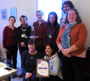 Some of the Healthy Homes team pose with two of their awards